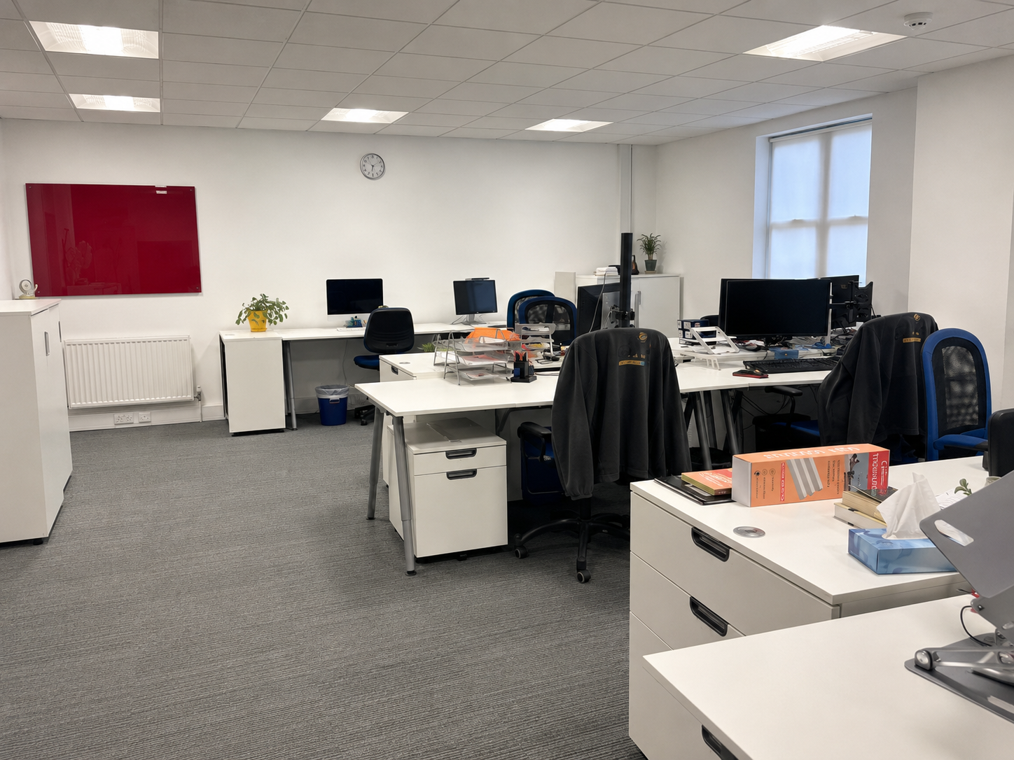 Open-plan office clean and ready for normal use after repair work.