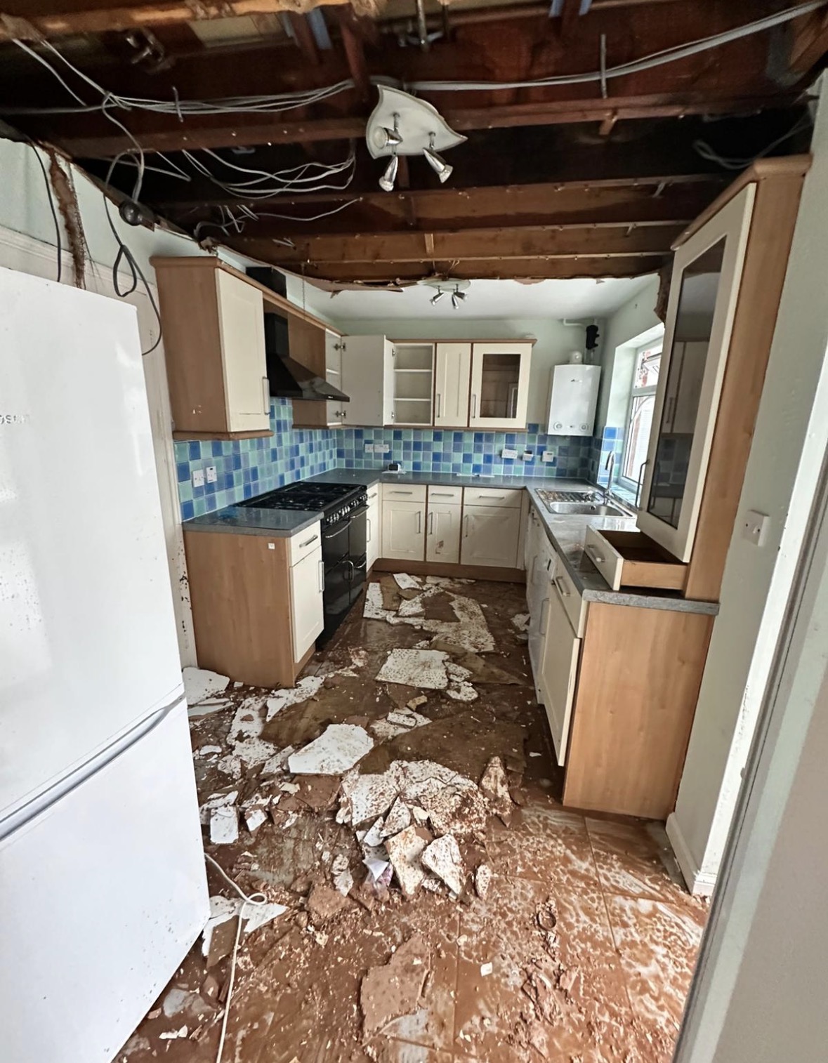 Kitchen with plasterboard ceiling collapsed after an escape of water above