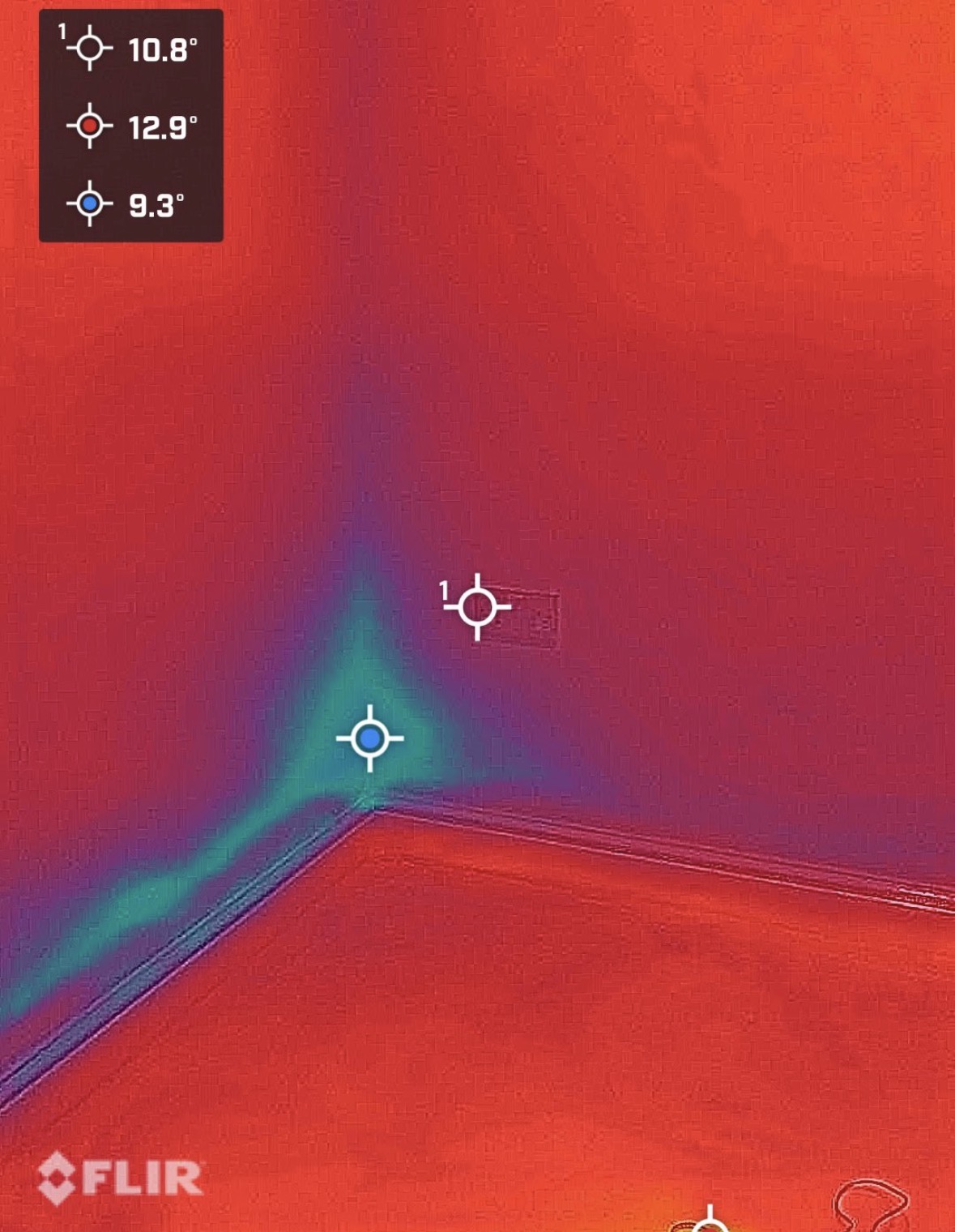 Thermal image showing a cooler pattern at a wall and floor junction.