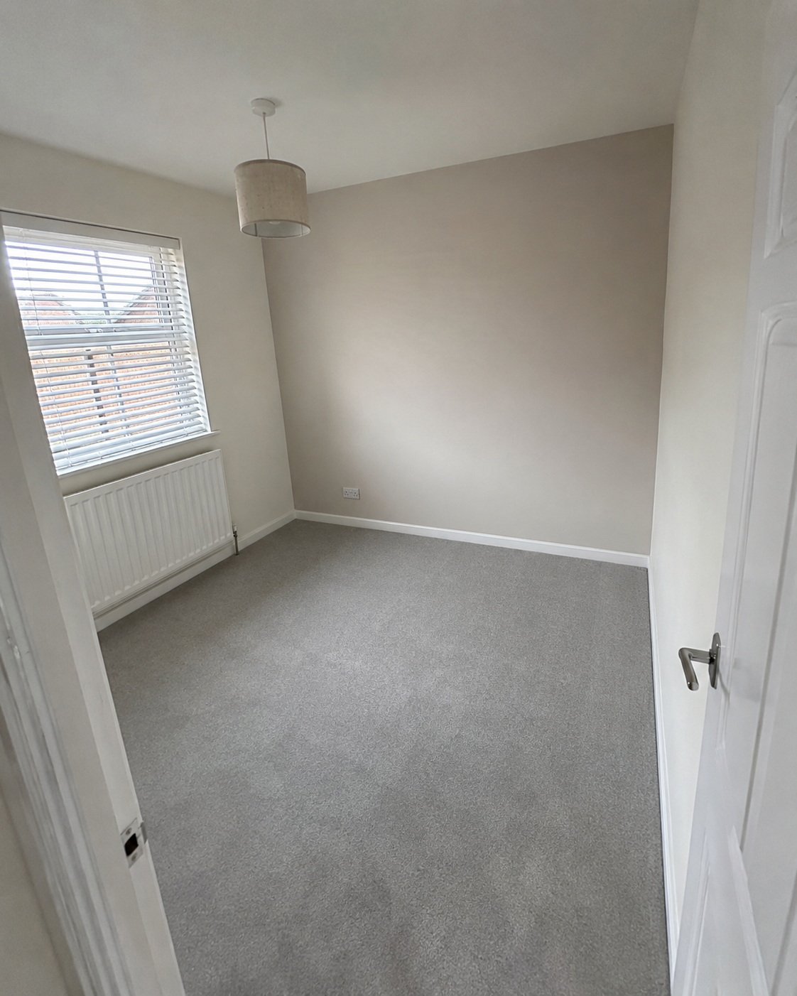 Completed smaller bedroom after plaster repair and redecoration