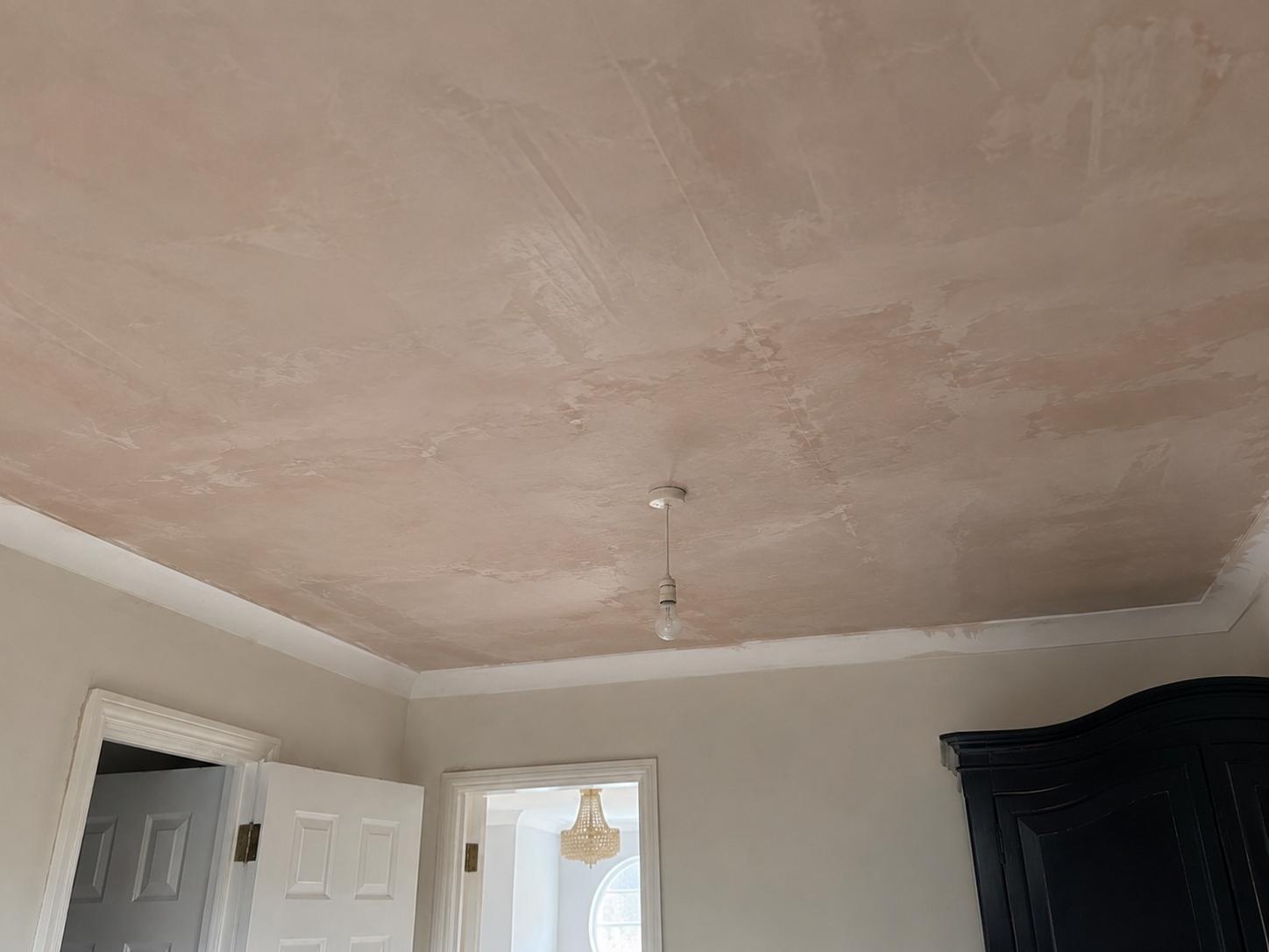 Freshly plastered bedroom ceiling curing after repair