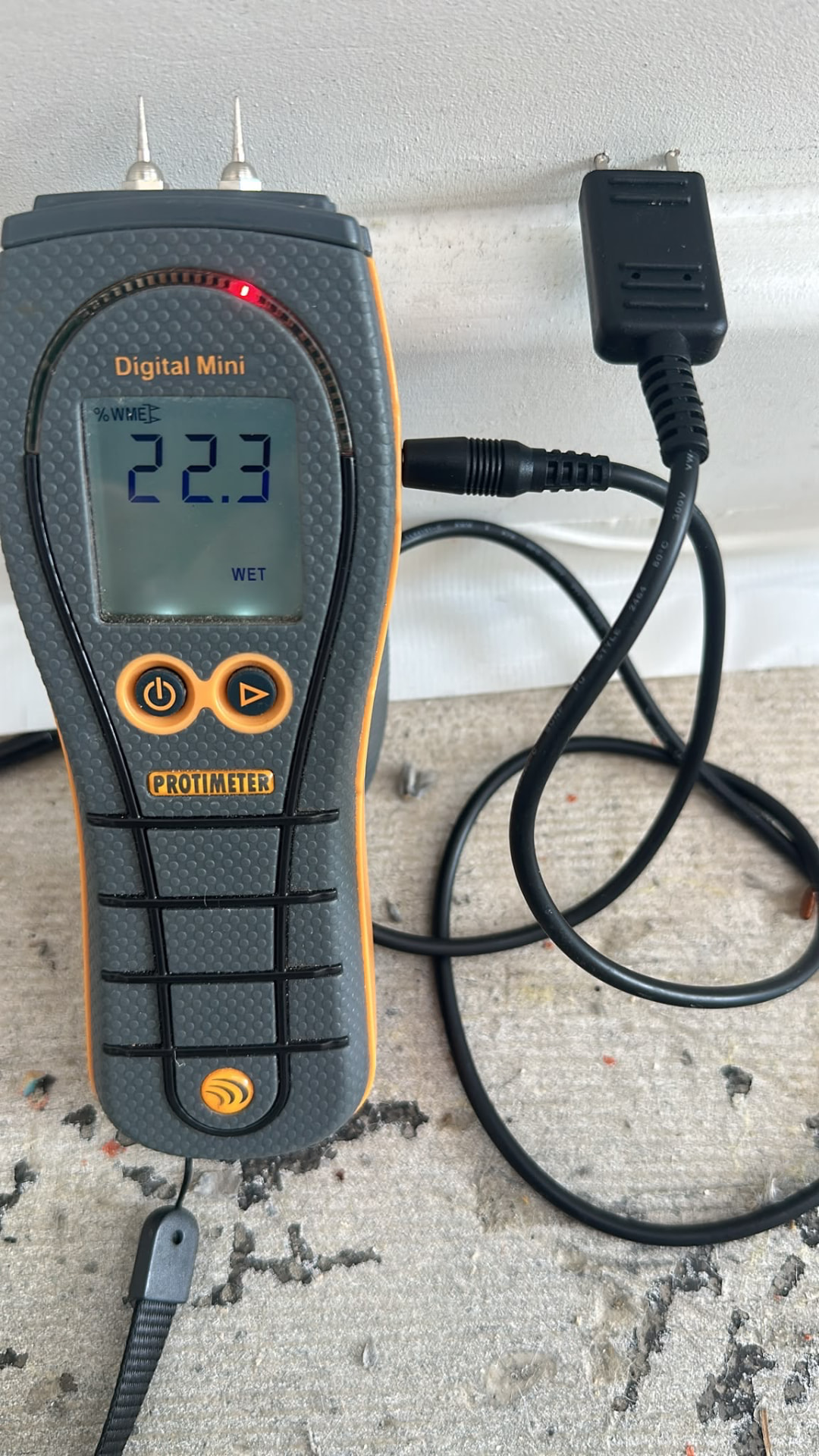 Protimeter Digital Mini reading taken at a floor and skirting junction
